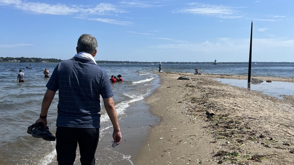 man walking along beach