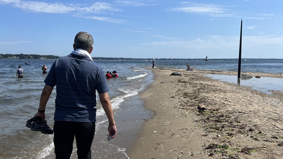 man walking along beach